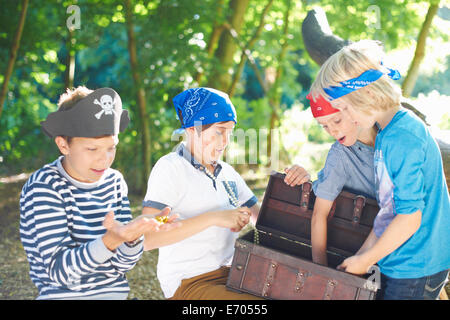 Young boys dressed as pirates with treasure chest Stock Photo