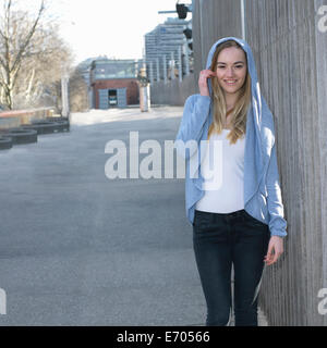 Portrait of young woman wearing hooded top Stock Photo
