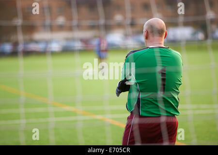 Rearview of goalie at football game Stock Photo