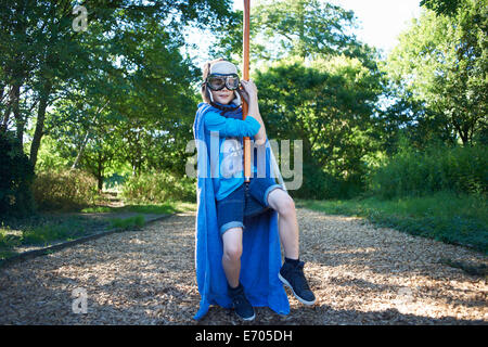 Young boy in fancy dress, on zip wire Stock Photo