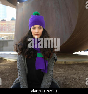 Portrait of young woman in knit hat and scarf at city underpass Stock Photo