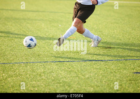 Football player kicking ball Stock Photo - Alamy