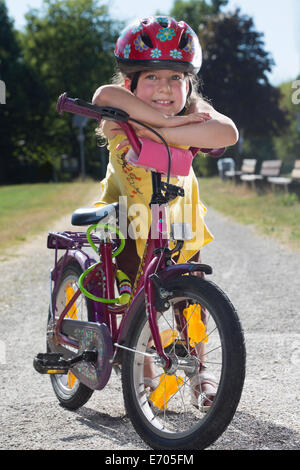 Young girl leaning on bicycle, portrait Stock Photo