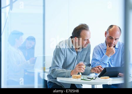 Business people having discussion over lunch Stock Photo