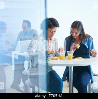 Business people having discussion over lunch Stock Photo