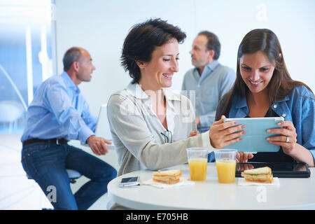 Business people having discussion over lunch Stock Photo