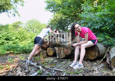 Two young women runners taking a break in forest Stock Photo