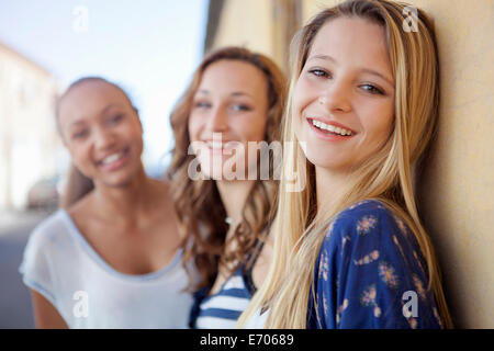 Teenage girls in street by side of house Stock Photo