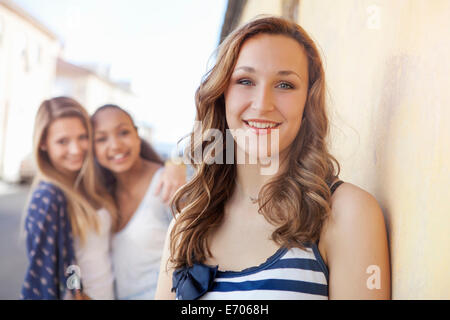 Teenage girl, friends in background Stock Photo