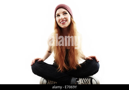 Studio portrait of young woman sitting cross legged on floor Stock Photo