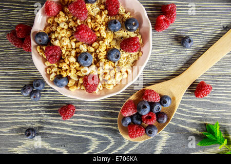 Cereal and fresh fruits arranged on a wooden table Stock Photo
