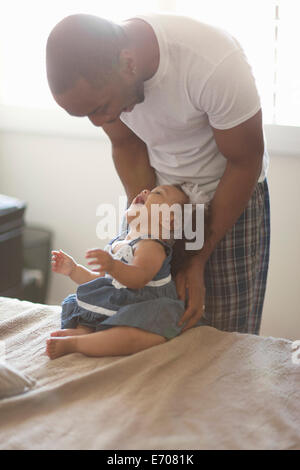 Father laughing with baby daughter Stock Photo