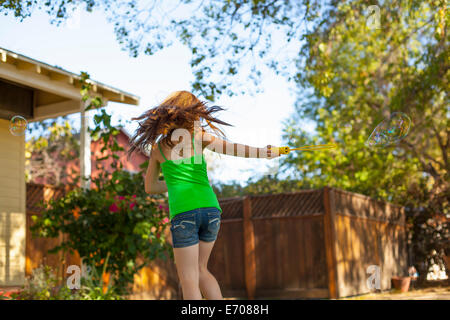 Girl running in garden Stock Photo