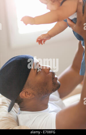Father lifting young daughter in the air Stock Photo