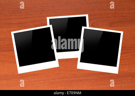 Blank, black picture frames with copy space on wooden table. Stock Photo