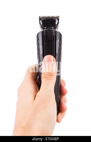 Hand holding electric shave machine, isolated on white background. Stock Photo