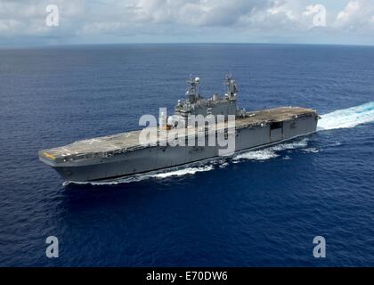 US Navy amphibious assault ship USS Peleliu prepares to deploy to the Western Pacific August 12, 2014 as it transits the Pacific Ocean. Stock Photo