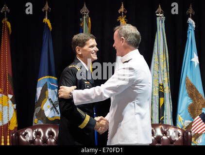 US Army Gen. Joseph L. Votel III is congratulated by retiring Adm. William H. McRaven during his promotion ceremony to head the Special Operations Command August 28, 2014 in Tampa, Florida. Votel replaces McRaven. Stock Photo