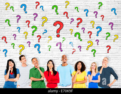 Group Of Multi-Ethnic Casual People Looking Up At The Question Marks Stock Photo