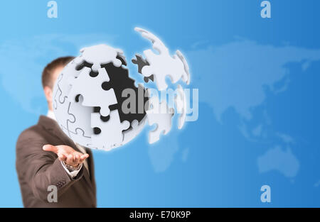Business man hold exploding ball of gray puzzle pieces Stock Photo
