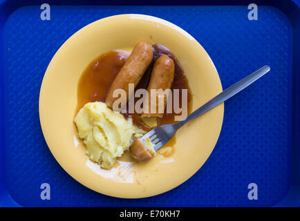 Hospital food. Patients meal (sausages, mash and gravy) on blue tray in NHS hospital in England. UK Stock Photo