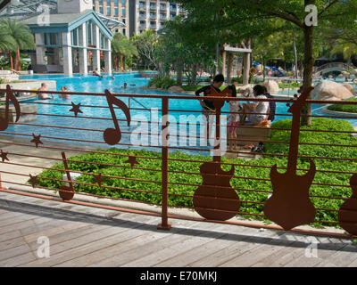 Tourists at the Hard Rock Hotel at Sentosa island in Singapore Stock Photo