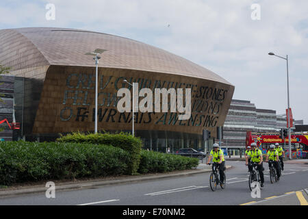 Cardiff, UK. 2nd Sep, 2014.  Police officers cycle in front of the Wales Millennium Centre. The police force are part of a massive security operation for the NATO Summit at the Celtic Manor, Newport. This is the first NATO Summit in the United Kingdom since 1990. Leaders from about 60 countries worldwide are expected to attend. Credit:  Owain Thomas/Alamy Live News Stock Photo