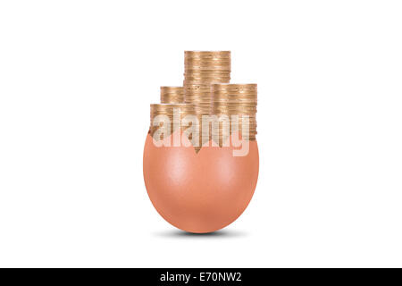 Coins in broken egg, isolated on white background. Stock Photo