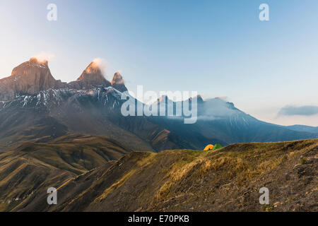 Aiguilles d'Arves mountain at dawn with two tents in front, Pelvoux, Dauphiné Alps, Savoie, France Stock Photo