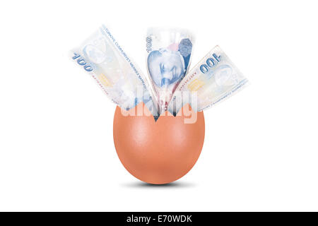 One hundred Turkish liras money banknotes in broken egg, isolated on white background. Stock Photo