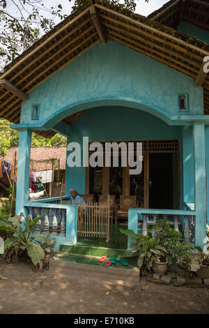 Borobudur, Java, Indonesia.  Javanese Village House, Woman on Porch. Stock Photo