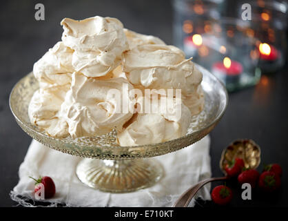 Dish of meringues with fresh strawberries Stock Photo