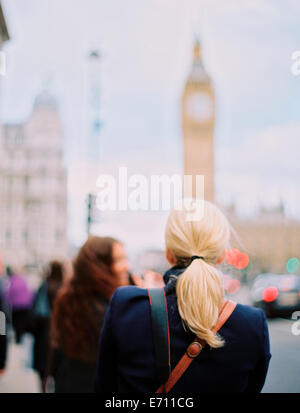 Two women in London on the street near Big Ben, The Elizabeth Tower in Westminster, in London. Stock Photo