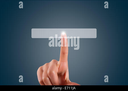Young female hand finger touching or pressing blank button on digital screen on dark background with copy space area. Stock Photo