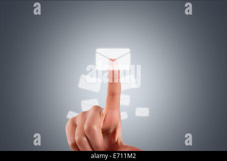 Communication concept, young female hand finger touching, pressing modern email button on digital screen interface on dark backg Stock Photo