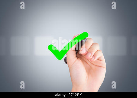 Young male hand holding pen and drawing tick in check box out of empty boxes on digital screen interface on virtual background. Stock Photo