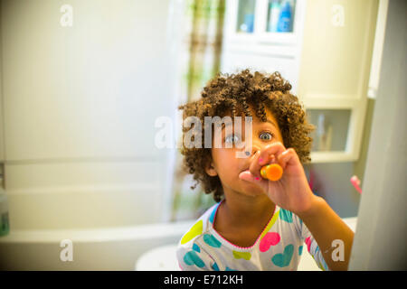 Young girls in cute blue swimsuits holding juicy oranges Stock Photo - Alamy