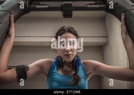 Young woman using gym equipment, portrait Stock Photo
