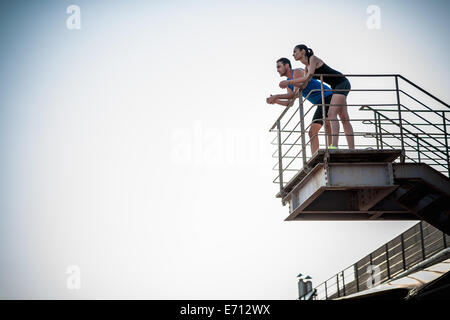 Couple standing on high platform, low angle Stock Photo