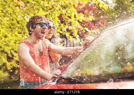 Young couple washing car Stock Photo