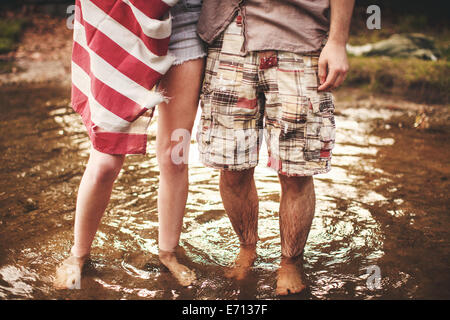 Young couple standing in shallow water Stock Photo