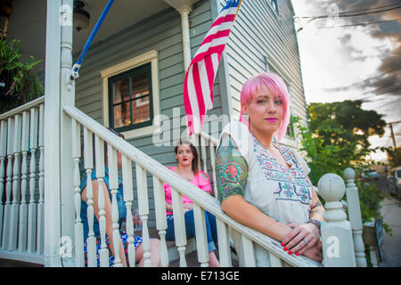 Portrait of three funky young adult friends on porch Stock Photo