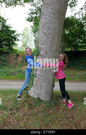 tree hugging children Stock Photo