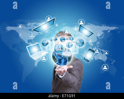 Business man hold Earth globe and electronics in hand Stock Photo