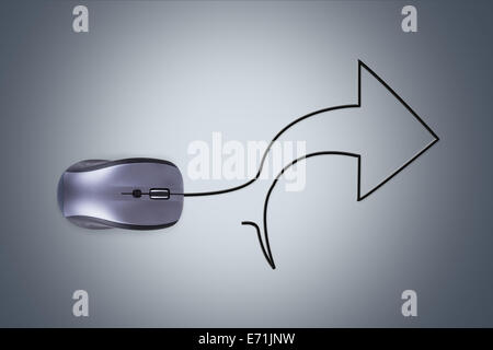 Mouse with cable in form of right arrow over dark background. Stock Photo