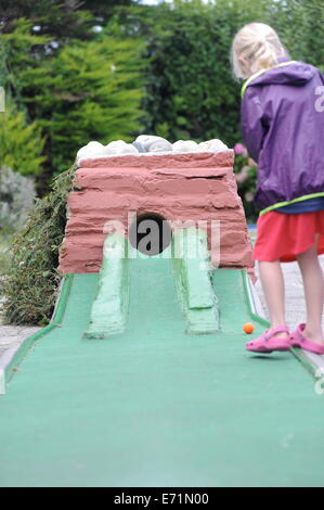 English children playing crazy golf in Newquay, Cornwall, Uk Stock Photo