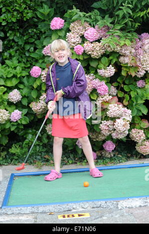 English children playing crazy golf in Newquay, Cornwall, Uk Stock Photo