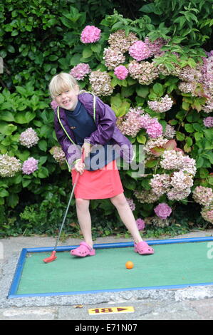 English children playing crazy golf in Newquay, Cornwall, Uk Stock Photo