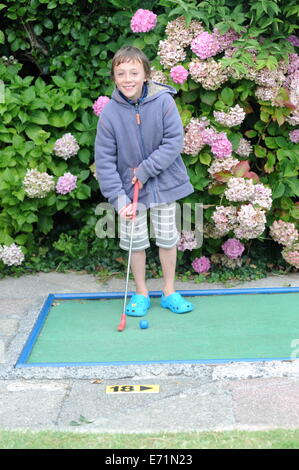 English children playing crazy golf in Newquay, Cornwall, Uk Stock Photo