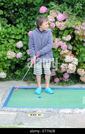 English children playing crazy golf in Newquay, Cornwall, Uk Stock Photo